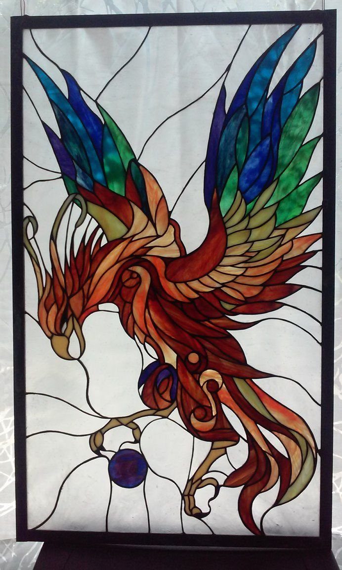 Colorful Stained Glass Design: 10 Ideas to Light a Room 10 A colorful stained glass phoenix with vibrant feathers set against a textured white glass background.